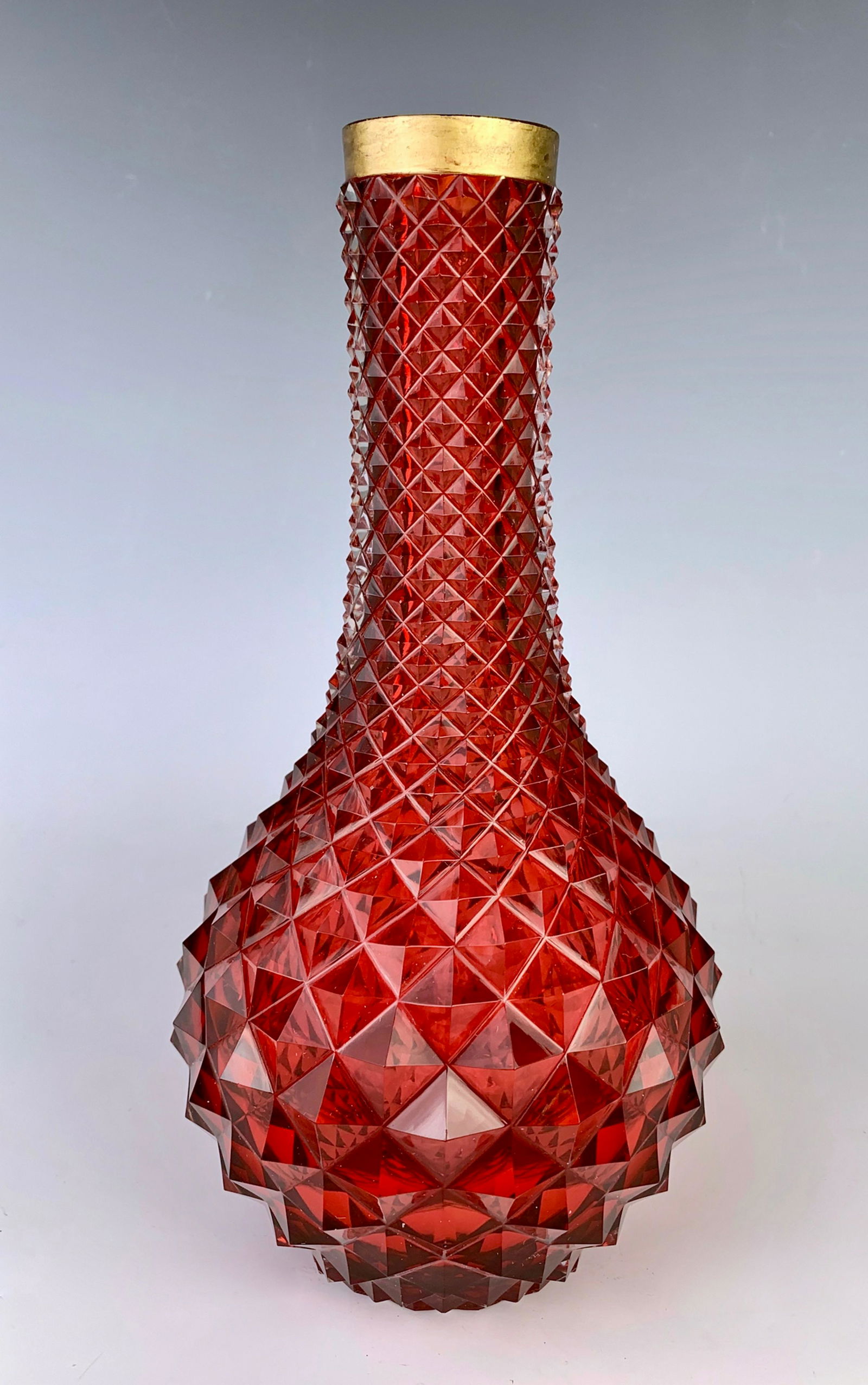 Antique Ruby Glass Vase with Bronze Collar: Circa 1900 Middle Eastern, possibly a hookah bottle, having a raised diamond quilted design and bronze collar, good condition, couple of minor flea bites, 10.25" x 5"