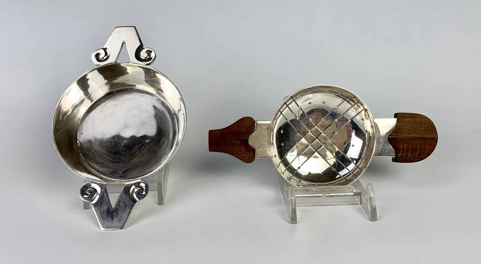 William Spratling Taxco Sterling Strainer & Dish: Mid 20th century, one tea strainer with 2 wood handles, the other is a dish with 2 sterling handles, 160 grams, both signed, very good condition, 5" x 7"