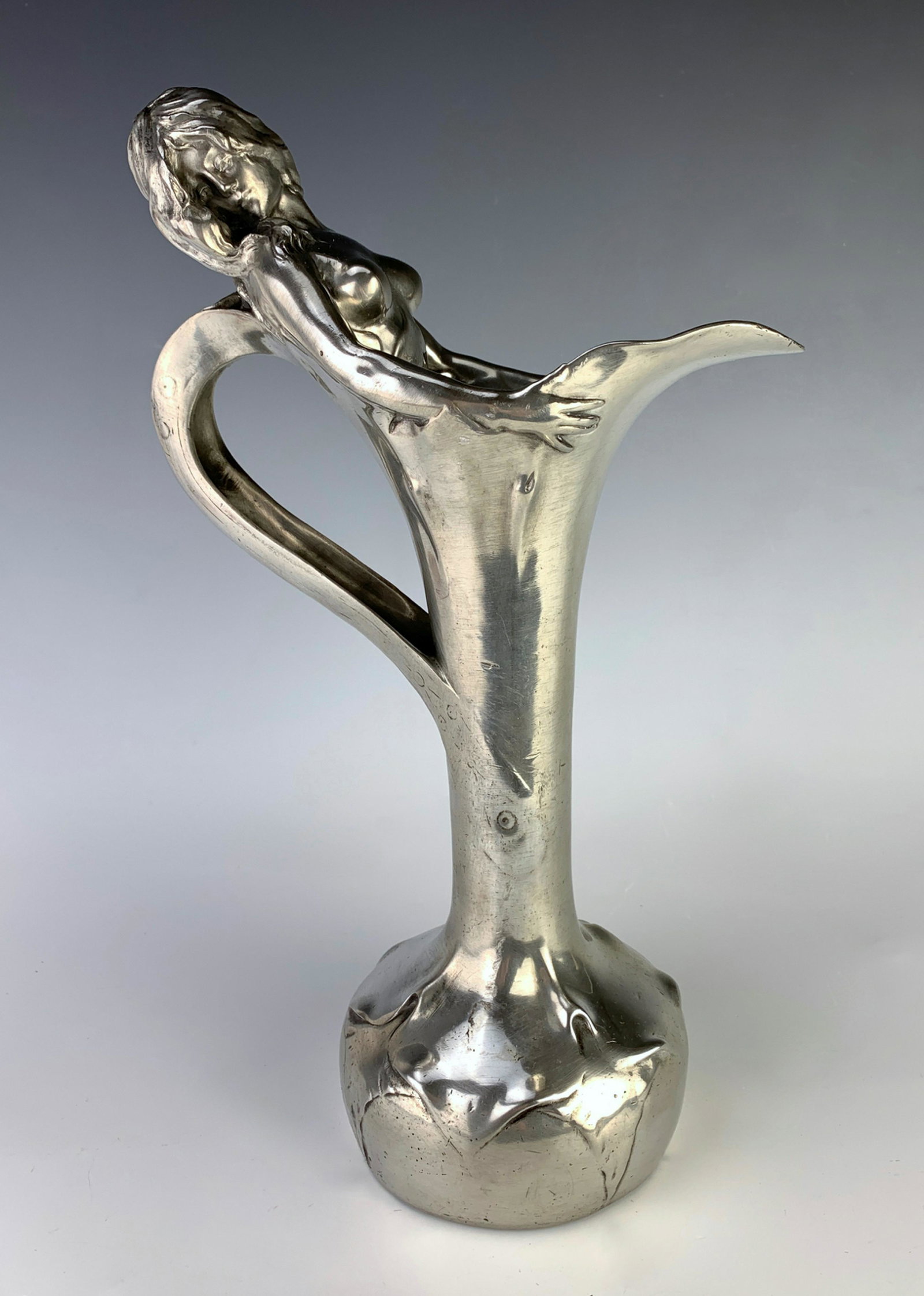 R.C.Peyre (1872-1949) Art Nouveau Decanter: Circa 1890's, figural decanter depicting a nude nymph rising out of the decanter with her wings forming the handle, made of pewter, signed "R. (Raphel) C. (Charles) Peyre (Paris)" with foundry seal fo