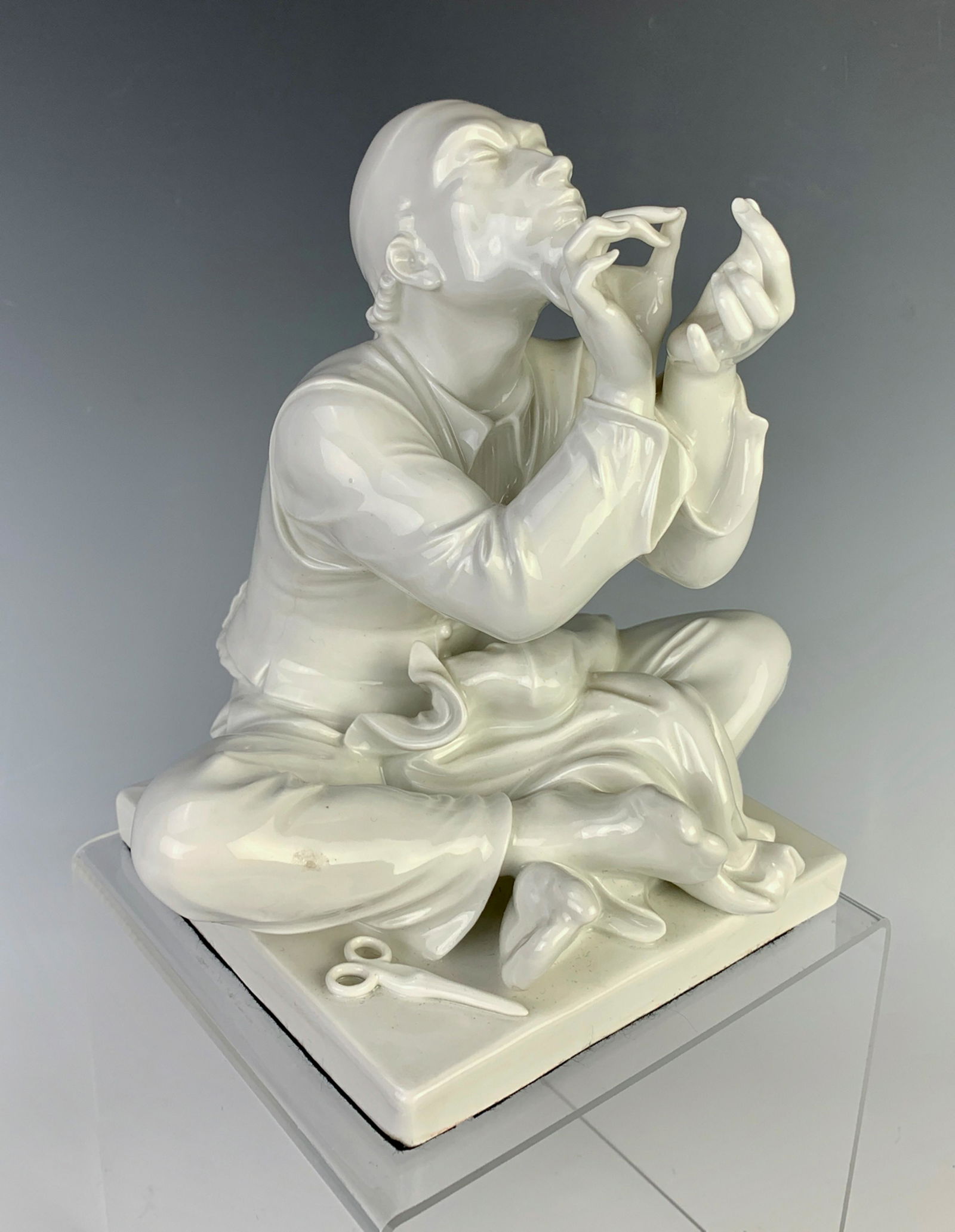 Meissen Blanc de Chine Figurine "Chinese Tailor": Made of porcelain and depicts a Chinese tailor threading a needle, artist signed "M. Strock" with Meissen blue cross sword mark (cancelled), very good condition, 7.5" x 7.25"