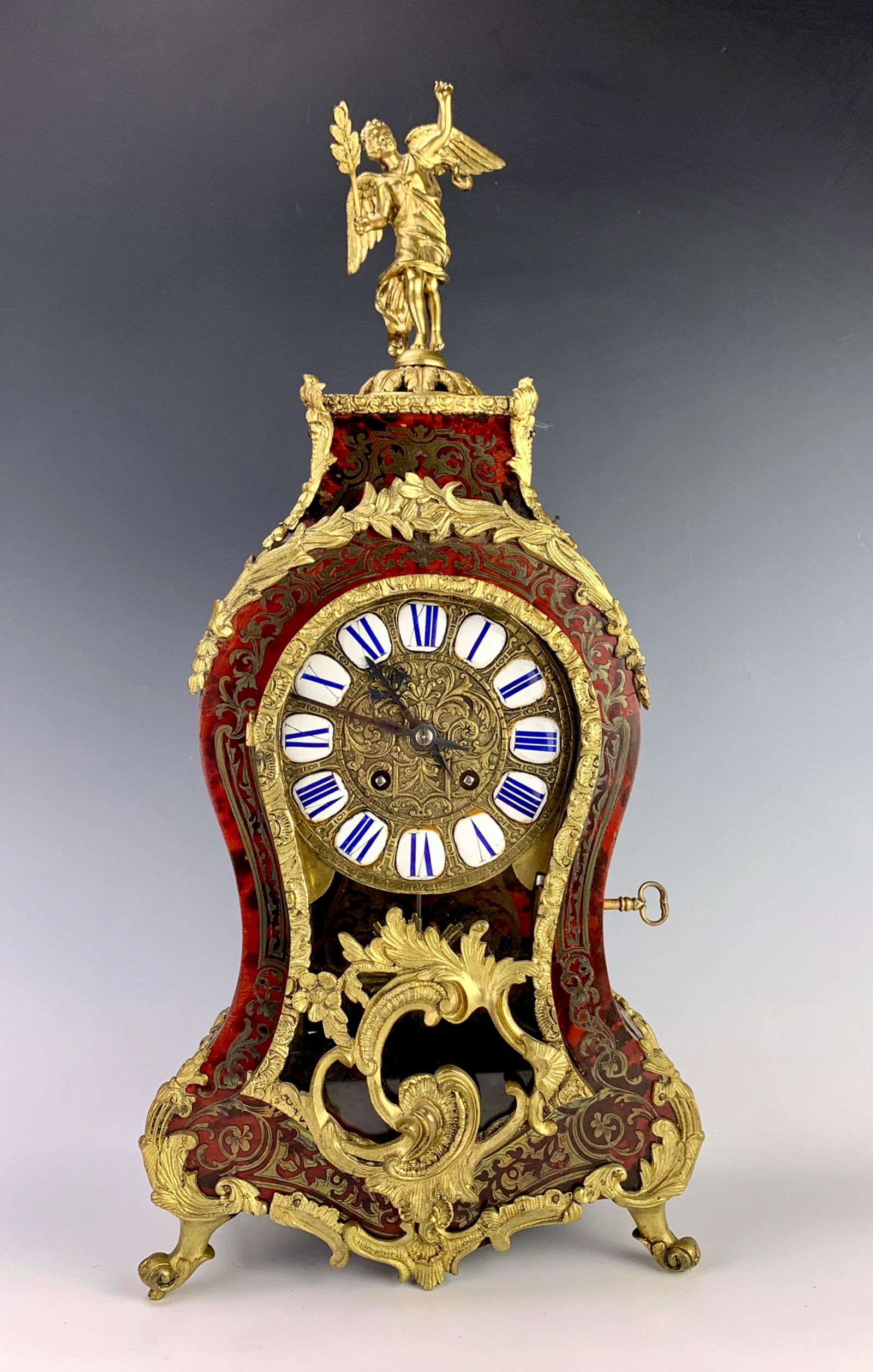 Antique Gubelin Swiss Boulle Clock: Stunning gilt bronze decorated boulle French cased clock with winged figural finial, bronze decorated dial with enamel numerals, key wind movement, marked "Gubelin", slight wear to case, exterior othe