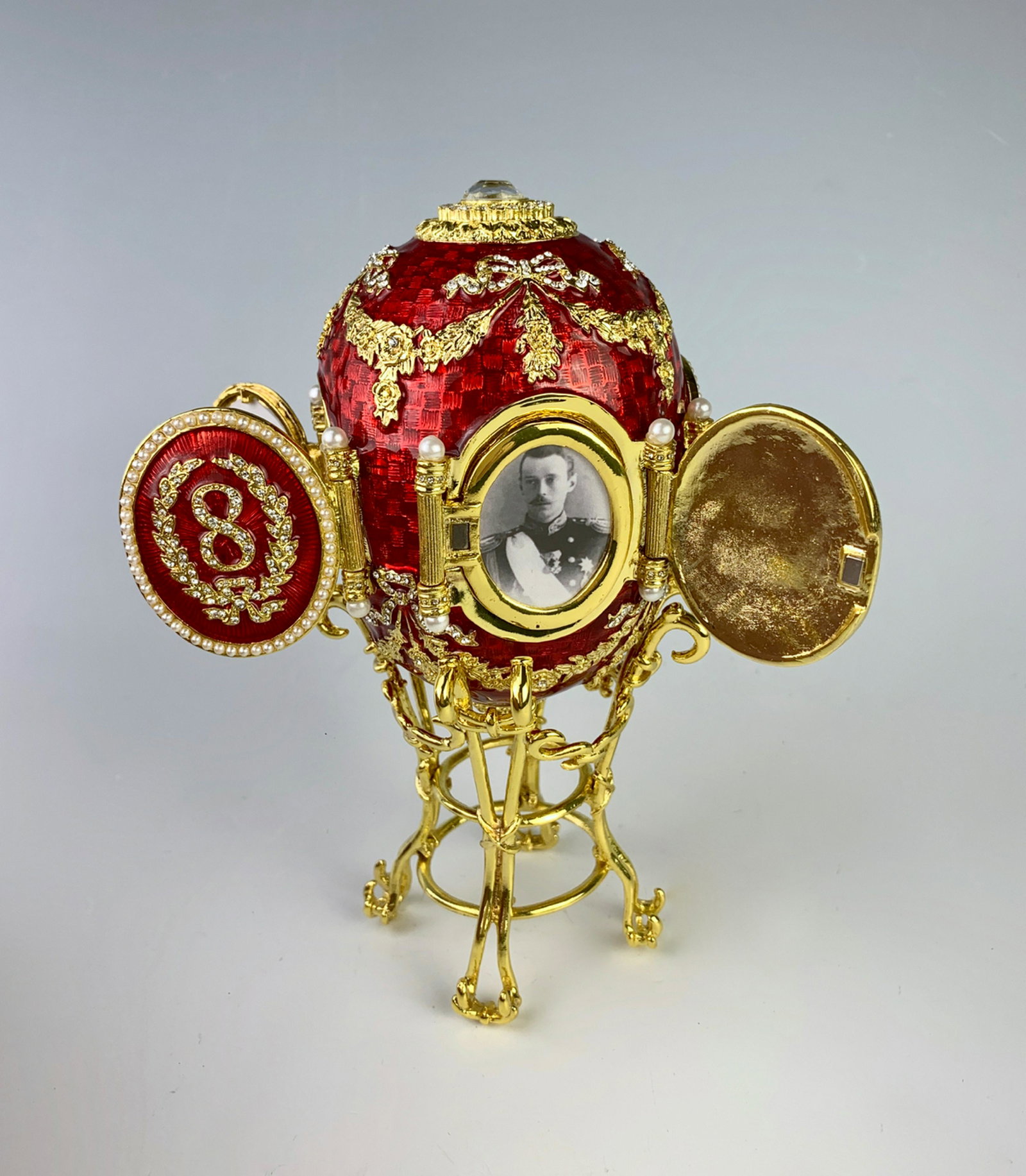 Faberge Style Red Enamel Egg w/ Picture Frames: Russian egg having 4 oval picture frames decorated with numbers 1, 8, 93 for 1893, on mounted stand and original box, good condition, 4" height, 7" height with stand
