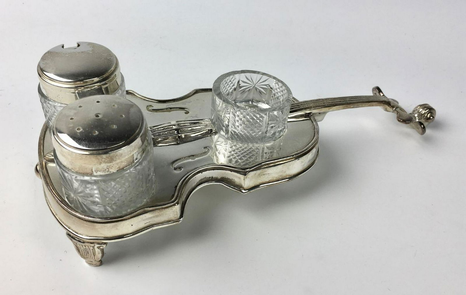 Silver Plate "Violin" Condiment Set: Having a violin shape with 3 bottles of glass, 2 with lids, has a crossed set of keys marks, very good condition, 9" length