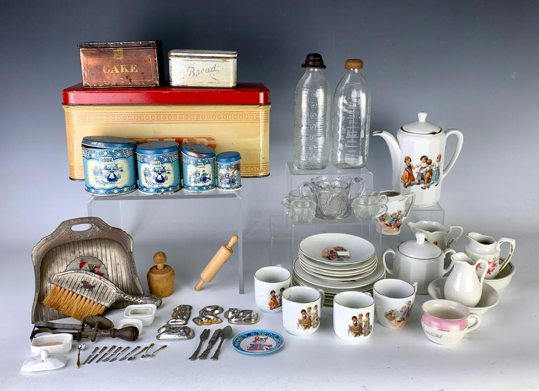 Large Group of Doll Kitchen Pieces c. 1920: Amazing collection of miniature doll kitchenware including 3 bread and cake tins, 2 baby milk bottles, miscellaneous china, crumb sweeper and brush, 2 porcelain soap dishes with soap bars, rolling pin