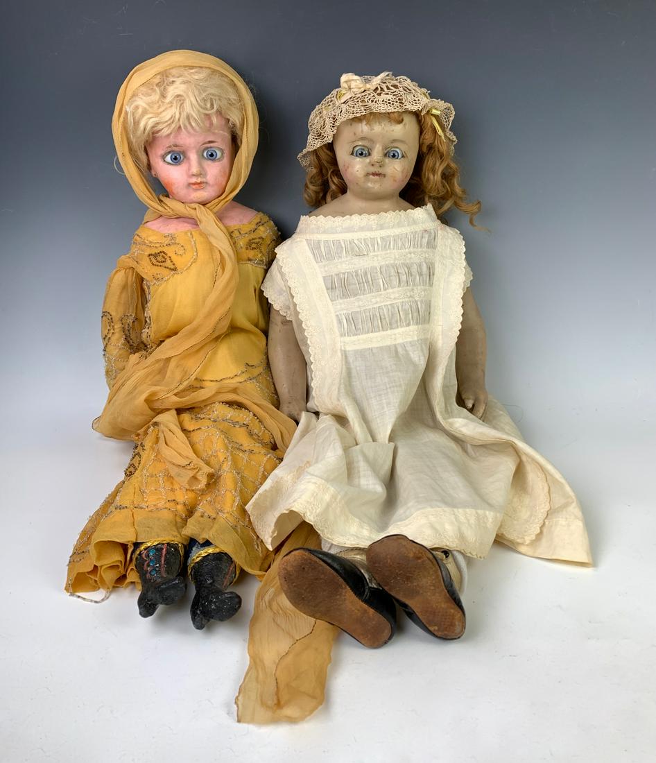 Lot of Two German Dolls: 27" German wax over composition shoulderhead, C. 1870, blue glass eyes, antique blond mohair wig, closed mouth, cloth body jointed at shoulders and hips, wood lower arms, composition lower legs with m