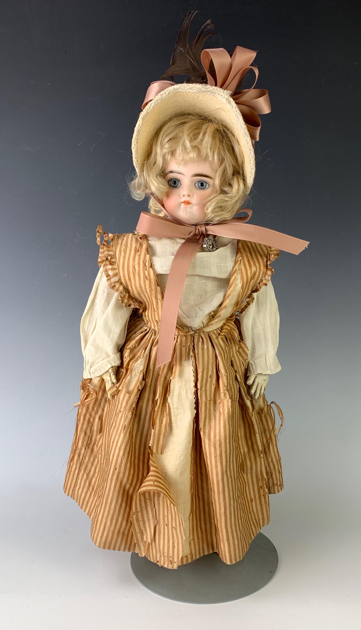 17" German Turned Head Bisque "G" by Kestner: C. 1880, blue glass set eyes, original blond mohair wig and plaster pate (never removed), closed mouth, sturdy bloth body that sits and stands, leather arms with separately stitched fingers, jointed a