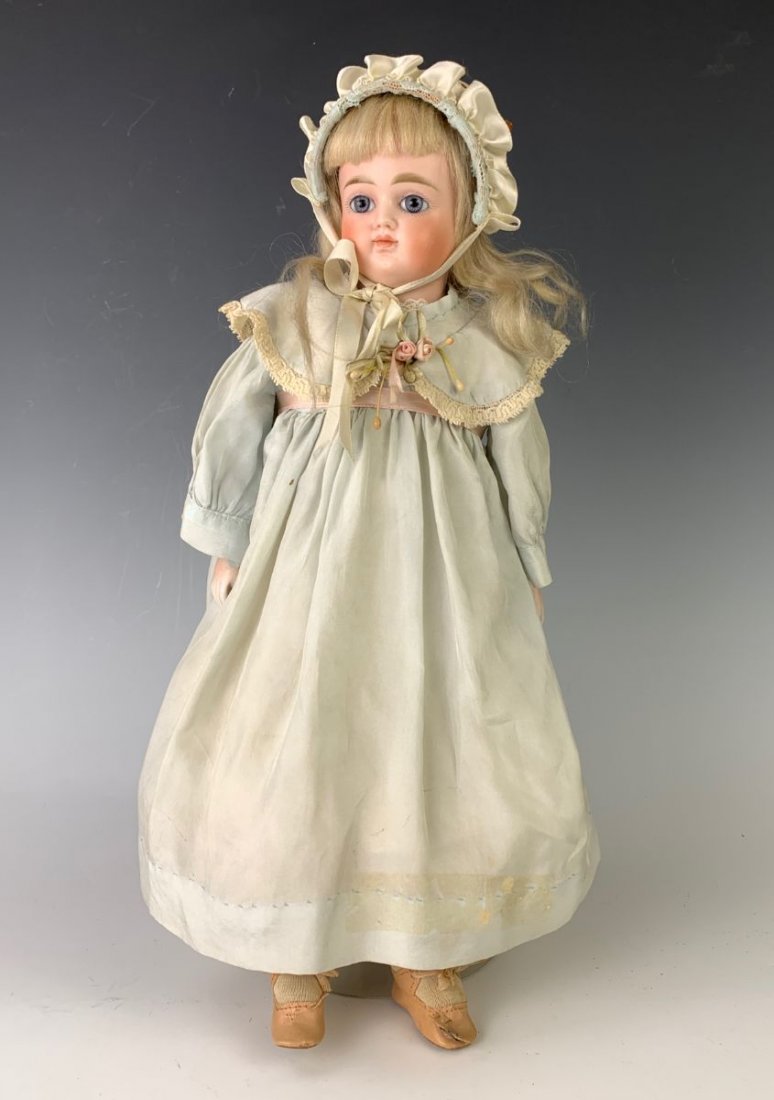 15" German Turned Bisque Shoulderhead by Kestner: C. 1885, blue paperweight eyes, original blond mohair wig and plaster pate, closed mouth, gusseted leather body jointed at shoulders, elbow, hips and knees, bisque forearms, left knee losing sawdust,