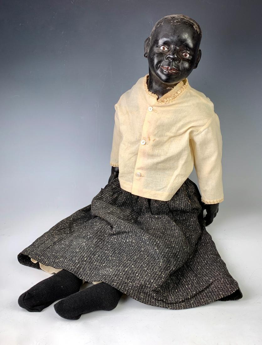 30" Early Black Wax Shoulderhead Character: C. 1900, brown glass set eyes, ethnic features, bald head, needs wig, original cloth body, arms attached with disc joints, legs sewn on, wax lower arms with beautifully posed hands, paint has rubbed o