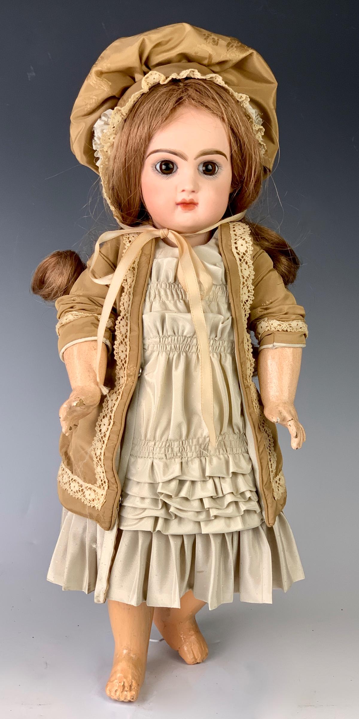 15.5" Bebe Reclame by Jumeau: C. 1885, brown paperweight eyes, newer French human hair wig, closed mouth, fully jointed composition body including wrists, stamped "Jumeau Medalle d'or Paris", wear to fingers, repaint on left foot,