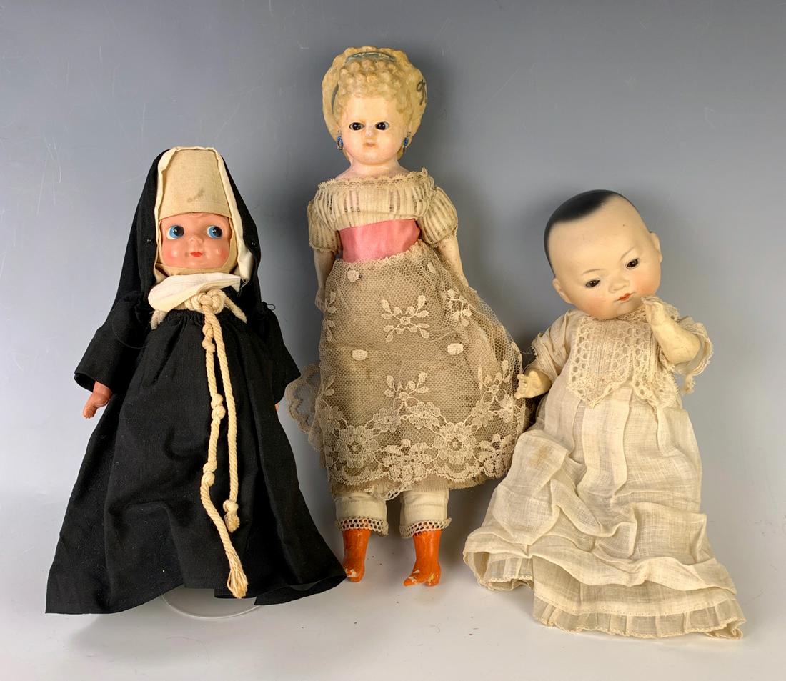 Lot of Three Dolls: 14" German Wax Over Papier Mache "Pumpkinhead" Shoulderhead, brown glass eyes, molded curly hair with hairband, pierced ears, cloth body with composition lower arms and legs, molded orange boots with 