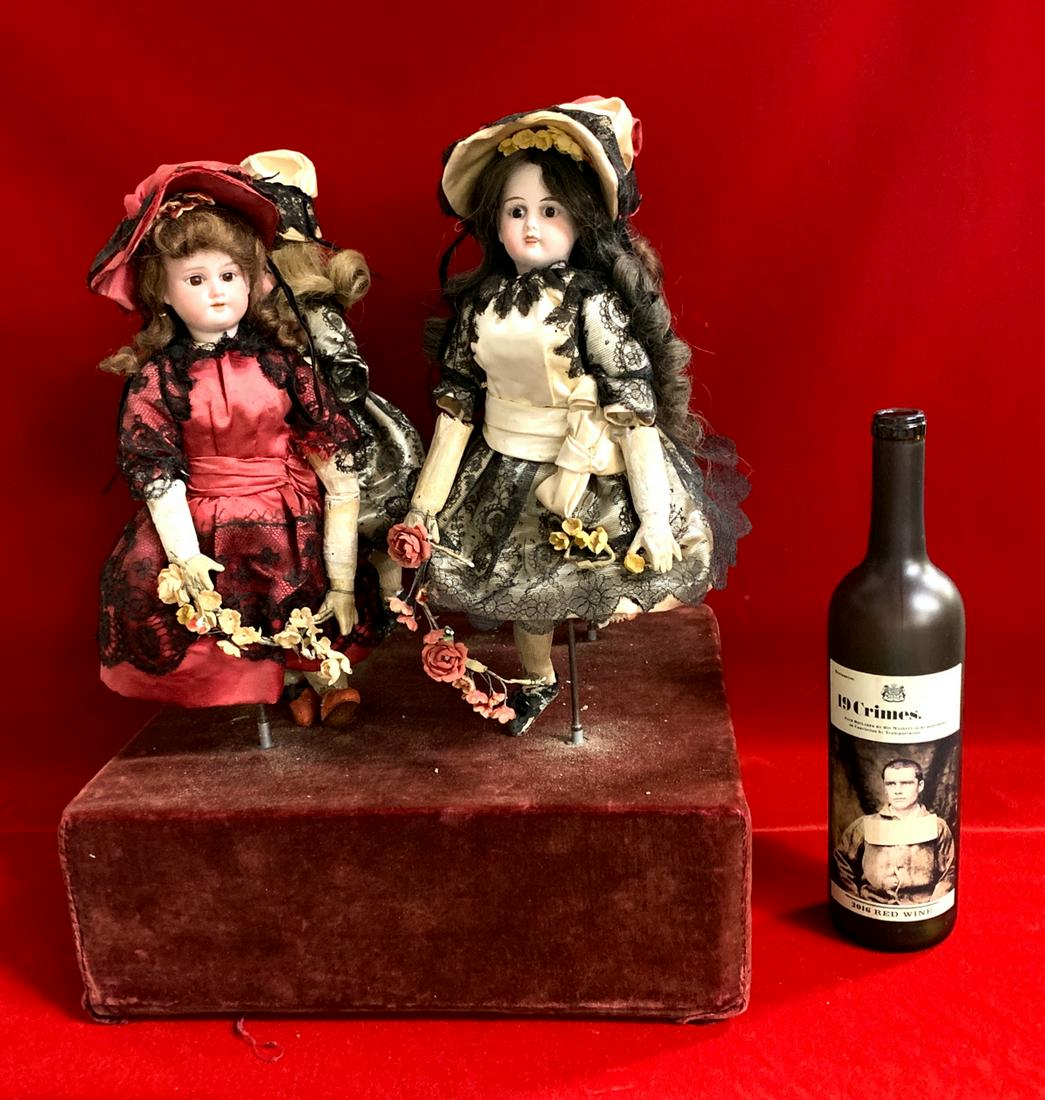 Large Antique 4 Bisque Head Musical Dancing Dolls: Having a red velvet box with key wind clockwork interior, set with 4 bisque head dolls, glass eyes, real hair wigs on composition bodies, when activated the dolls spin in unison as music plays, most l