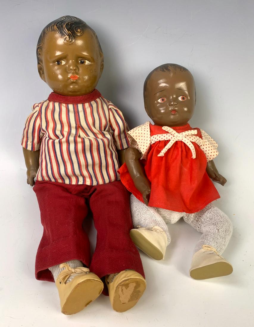 Lot of Two Dolls: 15" American Black "Baby Grump" Composition Shoulderhead by Effanbee, C. 1930's, brown side-glancing painted eyes, black molded hair, scowling expression,cloth torso with cloth upper les, compsition a