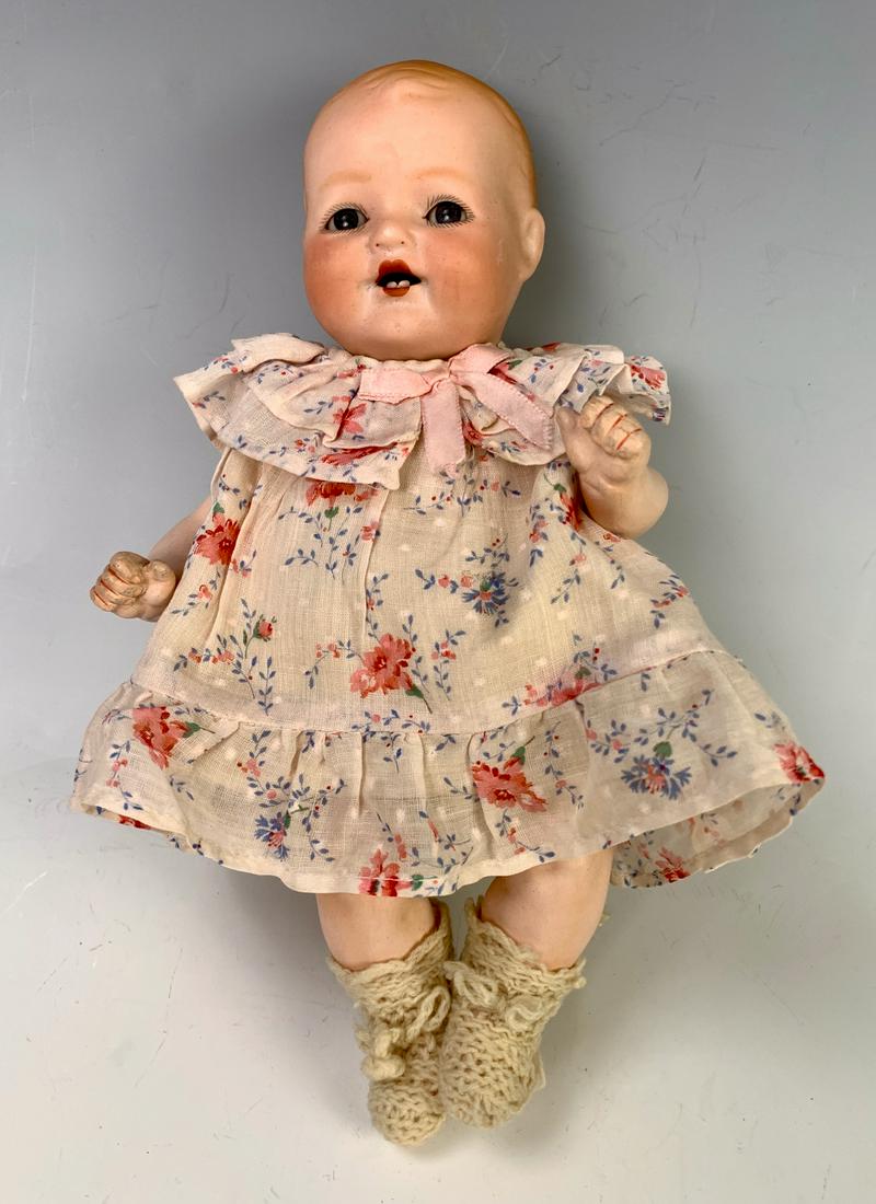 10.5" German Bisque Head Character Baby: C. 1910, made by Armand Marseilles, blue glass eyes (probably sleep eyes, but head stuffed), molded and painted auburn hair, open mouth with two bottom teeth, five-piece composition baby body with cle