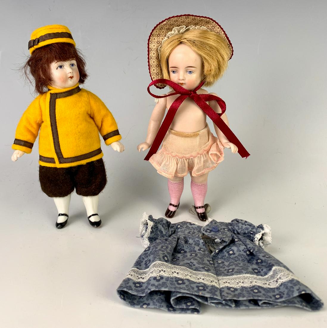 Lot of Two Dolls: 6" Girl with Stiff Neck, C 1885, blue painted eyes, blond human hair wig, closed mouthstraw jointed at shoulders and hips, clothing vintage, shirred pink stockings with brown molded Mary Jane shoes; 6
