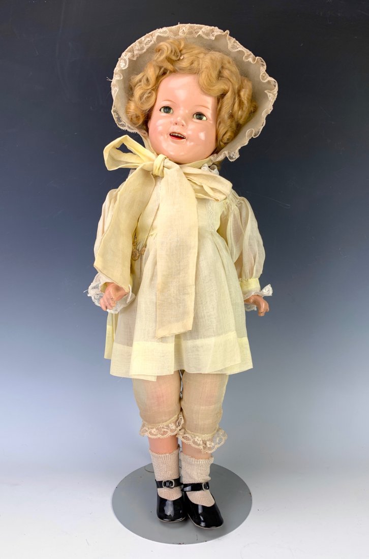 21.5" American Shirley Temple by Ideal: Circa 1935, unmarked, original wig, composition socket head and body, head possibly repainted, likely original clothing, good condition, call for more details