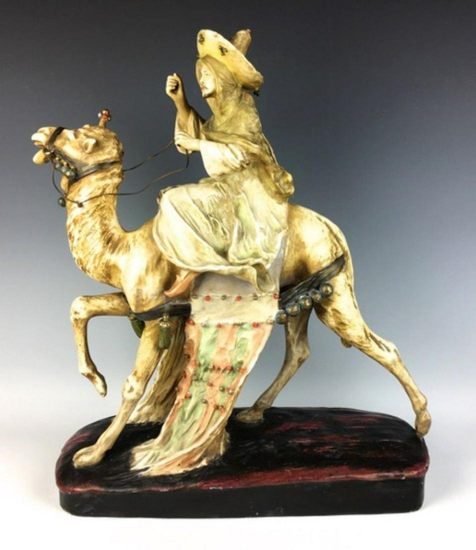 Amphora Camel and Rider: Circa 1900, depicting an Arab rider with hat, signed with Stellmacher & Teplitz stamp, made in Austria, areas of restoration, 19.25" x 17" x 6"