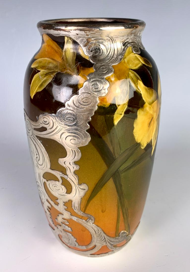 Rookwood Silver Overlay Vase C. 1914: Having silver overlay over a floral standard glaze body, signed with flame mark, artist signature "Caroline Steinle 80B", early professional restoration, 7" height