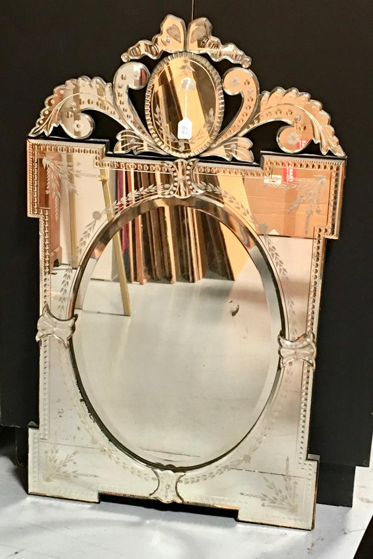 Antique Venetian Wall Mirror C. 1900: Elaborate antique Venetian mirror with ornate engraving, has beveled glass with many overlapping sections, good condition, a couple minor areas where silver is worn, 46" x 28"