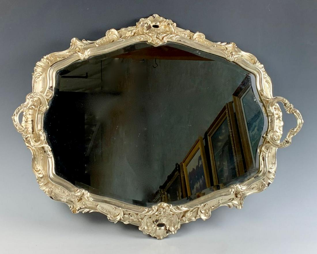 Louis XV Silvered Surtout De Table Mirror: The oblong shaped mirror top within a foliate and shell cast border and flanked by trefoil handles, good condition, 25.5" x 21"