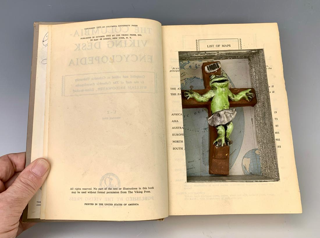 David Gilhooly (Am 1943-2013) Crucifrog in Book: Glazed ceramic sculpture in book, signed "David Gilhooly 1995", condition, 8.5" x 5.75"
