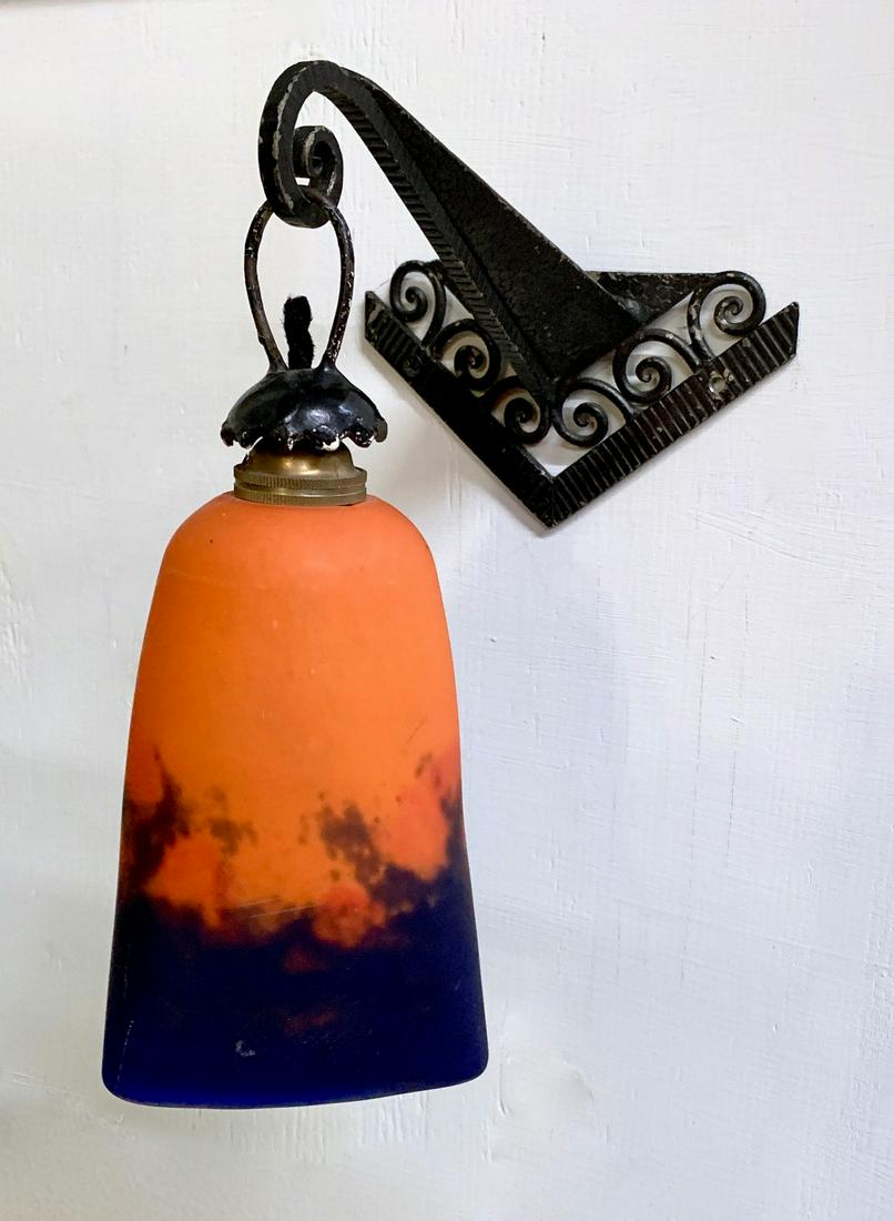 Degue Art Glass Wall Sconce Circa 1920: Orange and blue mottled glass shade, signed "Degue", French, mounted on an iron deco design wall bracket, good condition, has French socket, 5.5" shade height *Wiring should be inspected before use*