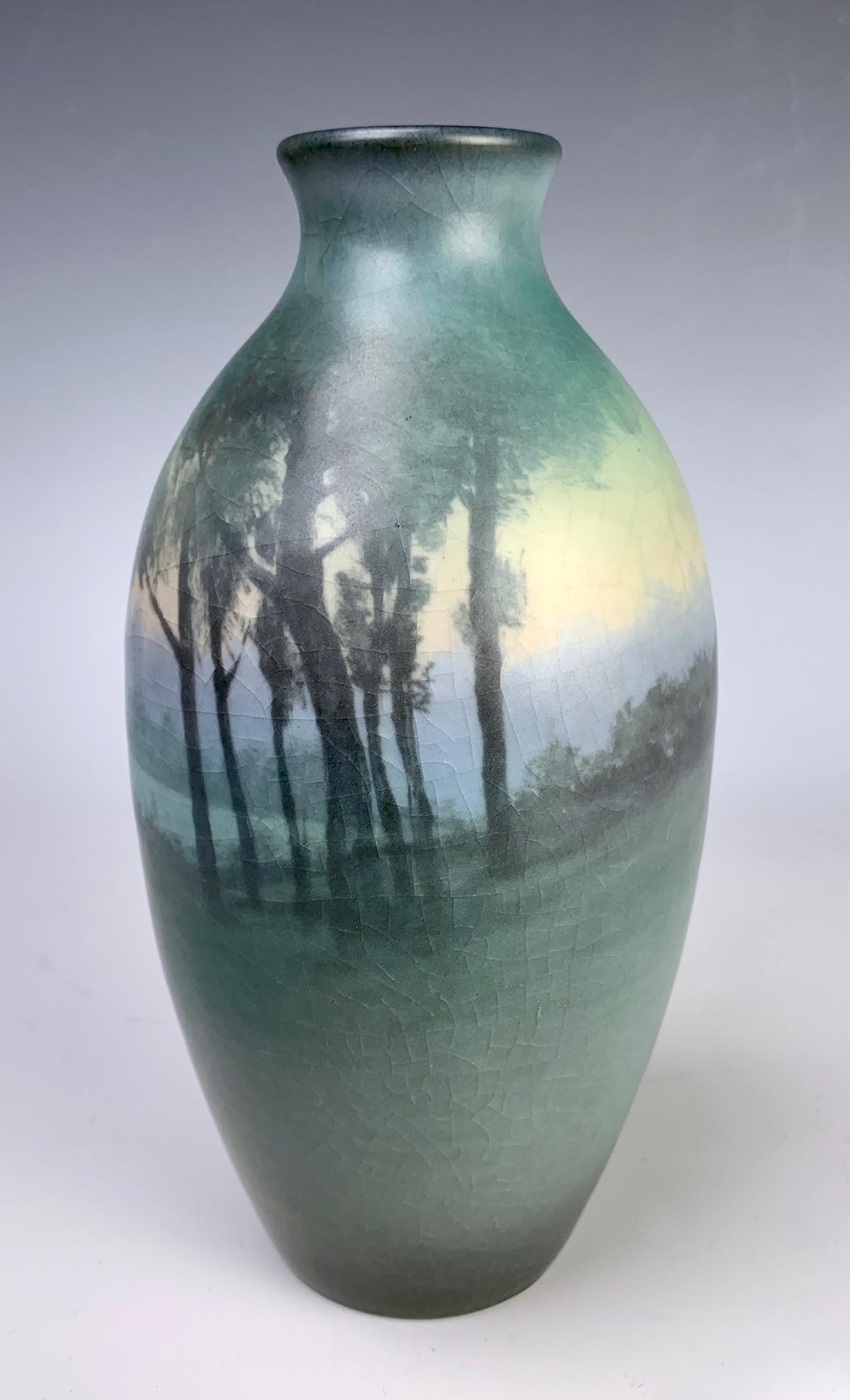 Rookwood Scenic Vellum Vase Sgd. Caroline Steinle: Fine painted landscape with trees in foreground, lake in the middle, artist signed "Caroline Steinle, XX (1920) 732C, V", good condition, some crazing, 6.75" height