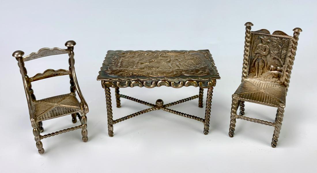 Sterling Miniature Table and 2 Chairs Circa 1900: Table has punch mark, 44 grams, 1.41 troy ounces, good condition, 2" tallest
