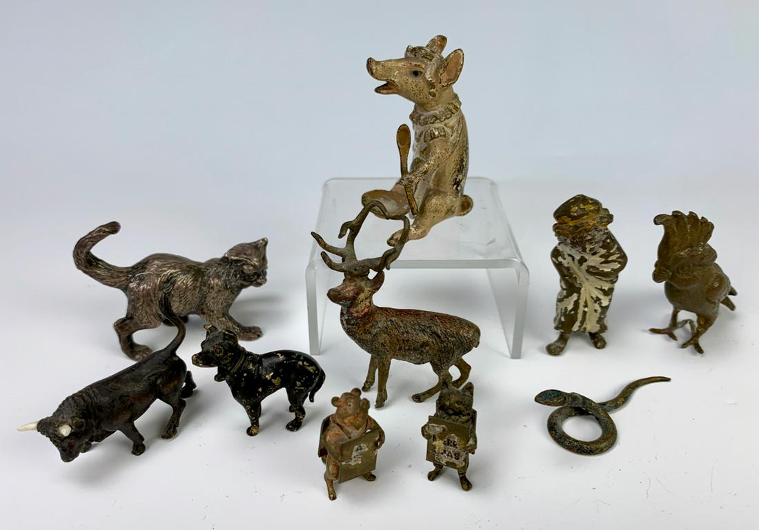 Group of 10 Austrian Mini Bronzes Circa 1900: Consisting of a sitting pig, deer, parrot, cat, bull, dog, pig with menu board, cat with menu board and a snake, paint wear commensurate with age, 1.75" tallest