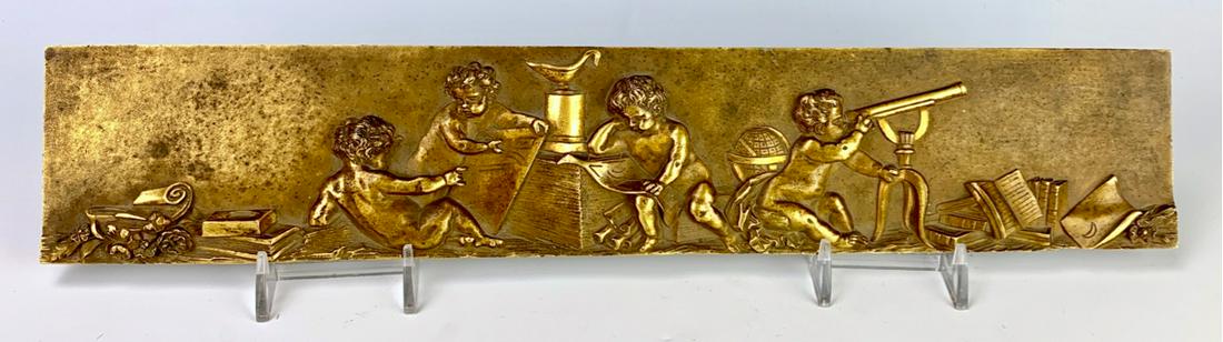 Bronze Plaque "Putti at Play" Circa 1880: Great quality gilt bronze 19th century plaque depicting 4 putti playing amongst telescope, world map and other related objects, good condition, 15.5" x 2.75"