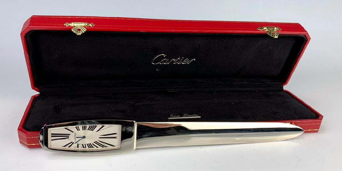 Cartier Letter Opener & Clock, Limited Edition: Elegant authentic paper knife with clock from Cartier in a platinum finish, dial is signed "Cartier", Swiss made, Roman numerals, signed on back "Cartier 1268/2000", comes with original Cartier displa
