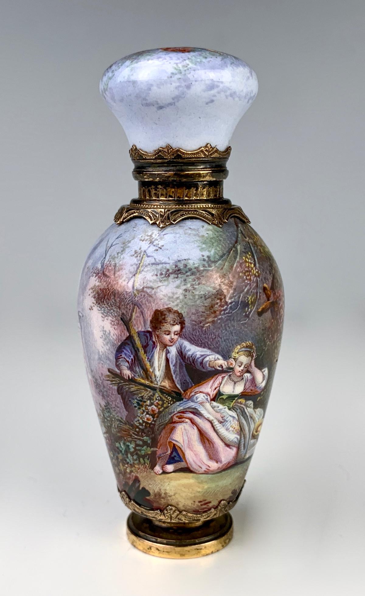 Viennese Enamel & Gilt Silver Perfume Bottle: Late 19th century, antique, beautifully enameled perfume bottle decorated with hand painted scenes of a young couple with ruins in background, top enamel cap having a bird with arrows and flames, with
