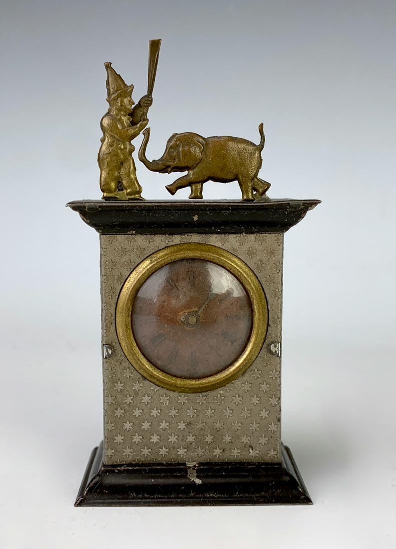Rare Antique German Tin Penny Toy Automaton: Very rare German tin penny toy automaton on a clock with 2 figures at top "Punch Figure & Elephant", when wound up the clock dial starts to go around, the elephant stands up while the Punch starts swi
