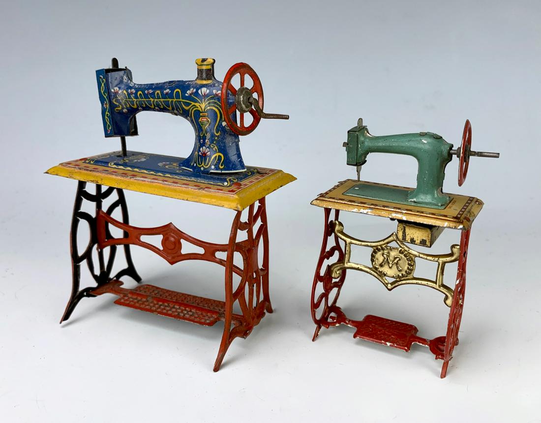 Lot of 2 Tin Antique Sewing Machine Penny Toys: 2 antique German embosses lithographed tin penny toy sewing machines, both have working mechanisms, very good condition, 4" tallest **Lifetime estate collection of Jeannine Hamilton, Oak Park, CA** *C