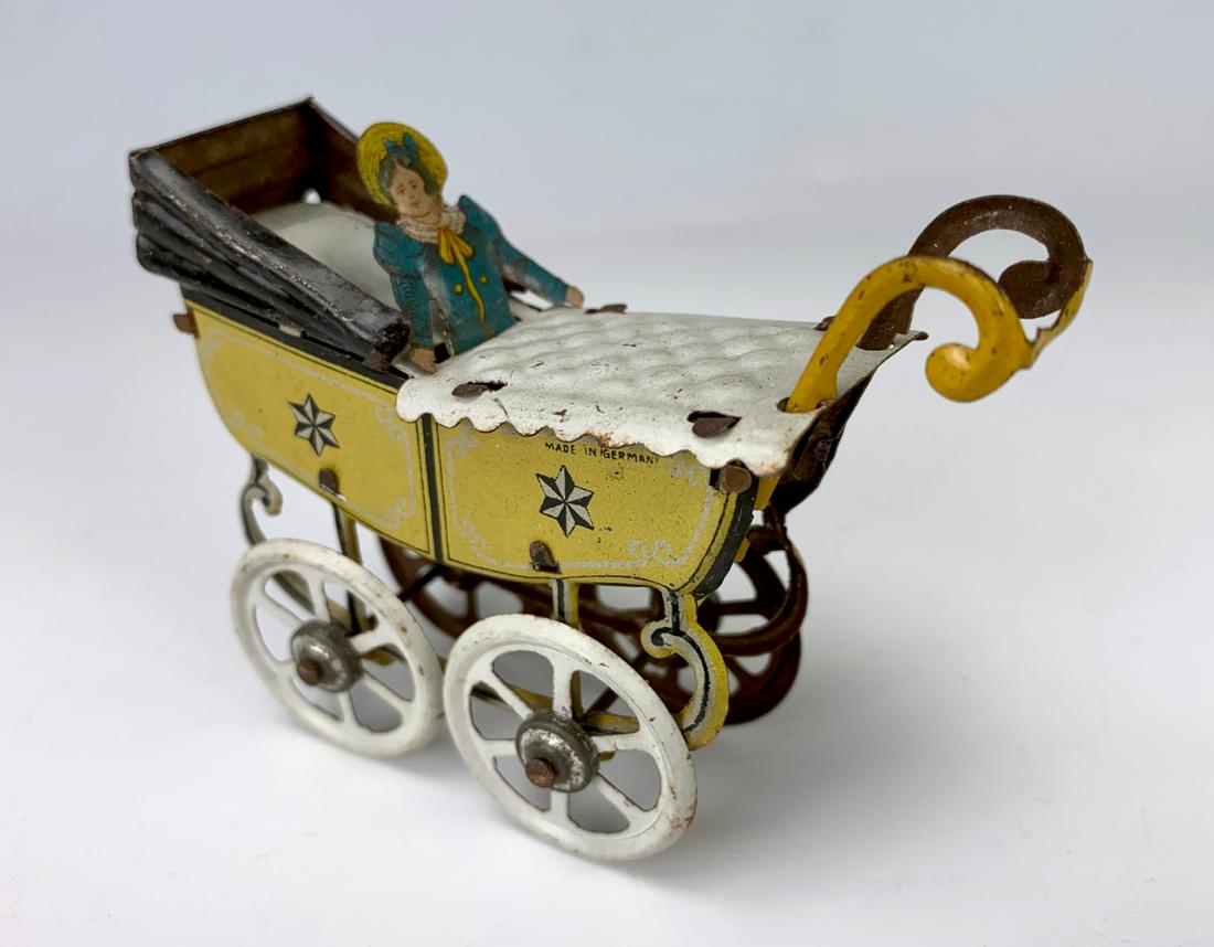 German Antique Penny Toy Baby in Carriage: Nice early German embossed lithographed tin penny toy "Baby in Carriage", very good condition, 2.5" height **Lifetime estate collection of Jeannine Hamilton, Oak Park, CA** *Domestic in-house shipping