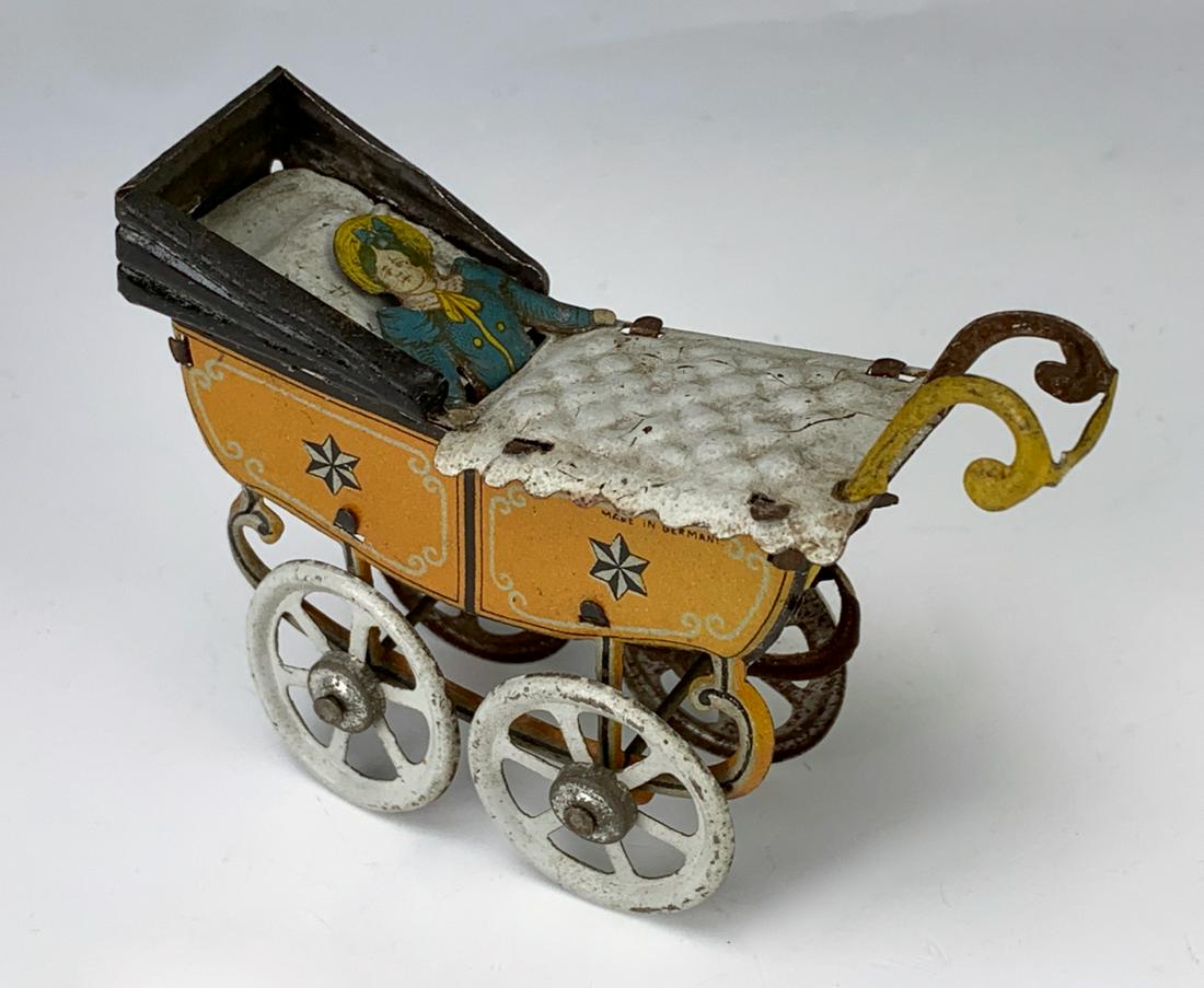 German Antique Penny Toy Baby in Carriage: Nice early German embossed lithographed tin penny toy "Baby in Carriage", very good condition, 2.5" height **Lifetime estate collection of Jeannine Hamilton, Oak Park, CA** *Domestic in-house shipping