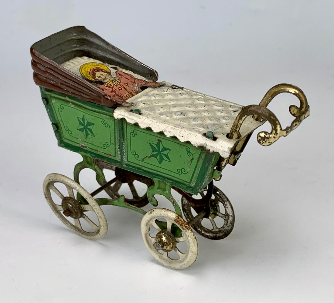 German Antique Penny Toy Baby in Carriage: Nice early German embossed lithographed tin penny toy "Baby in Carriage", very good condition, 2.5" height **Lifetime estate collection of Jeannine Hamilton, Oak Park, CA** *Domestic in-house shipping