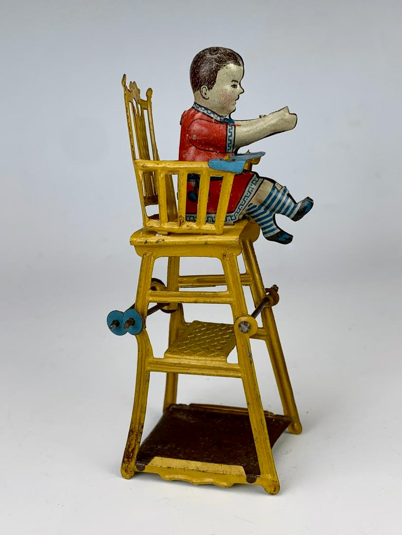 Antique German Tin Litho "Baby in High Chair" Toy: Early German embossed lithographed tin penny toy "Baby in High Chair", 2 connecting pieces, very good condition **Lifetime estate collection of Jeannine Hamilton, Oak Park, CA** *Domestic in-house shi