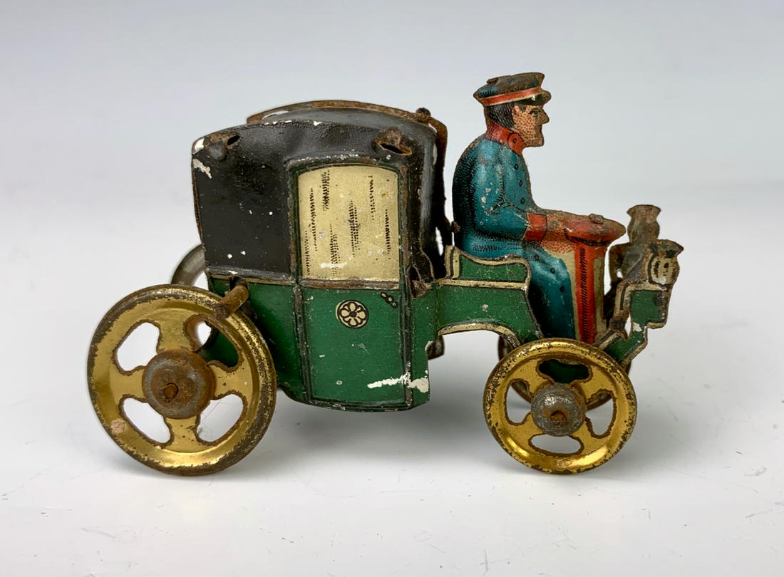 Antique German Tin Penny Toy "Coach & Driver": Early tin embossed lithographed penny toy of a coach and driver, very good condition, 2" height **Lifetime estate collection of Jeannine Hamilton, Oak Park, CA** *Domestic in-house shipping available