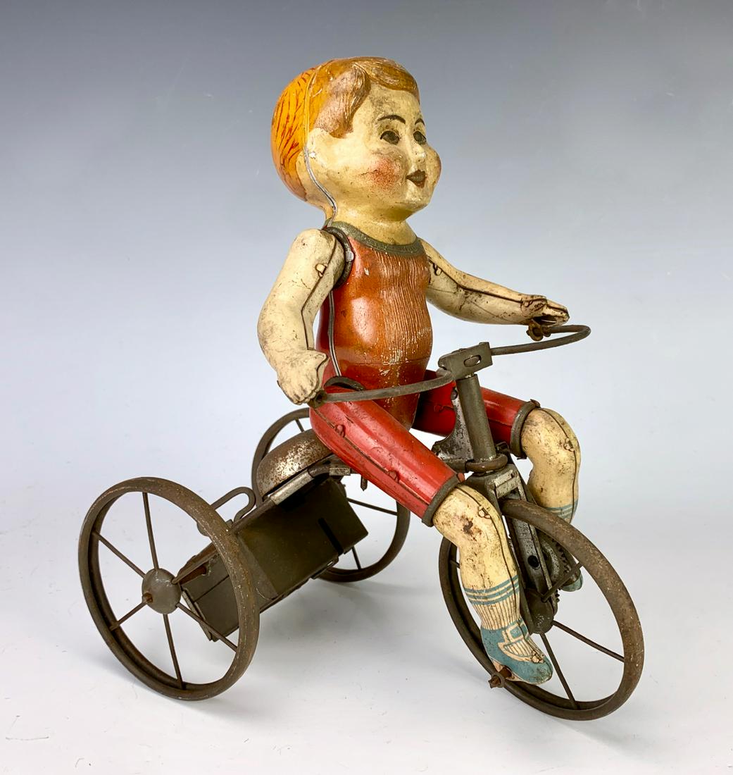 Antique Tin Toy "Boy on Tricycle" Clockwork Toy: Having a tin lithographed boy riding a tricycle, good condition, works fine, 9" height **Lifetime estate collection of Jeannine Hamilton, Oak Park, CA** *Contact us to see this lot in action* *Mechani