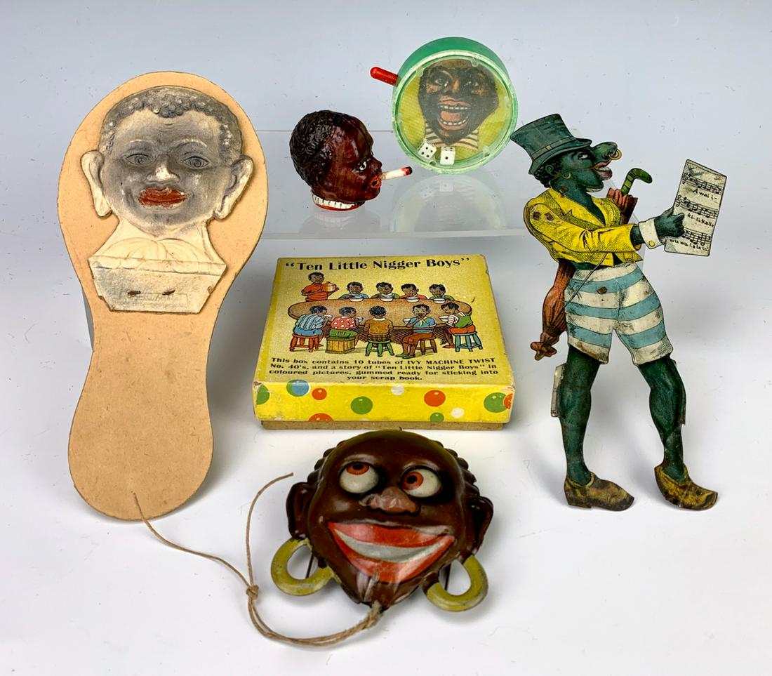 Group of 6 Black Collectible Toys: Consisting of tape measurer, tin string pull eyes, dice game, rattle, boxed set and a lithographed tine pull toy (when pull mouth opens lifting sheet music), good condition, 6.5" longest **Lifetime es