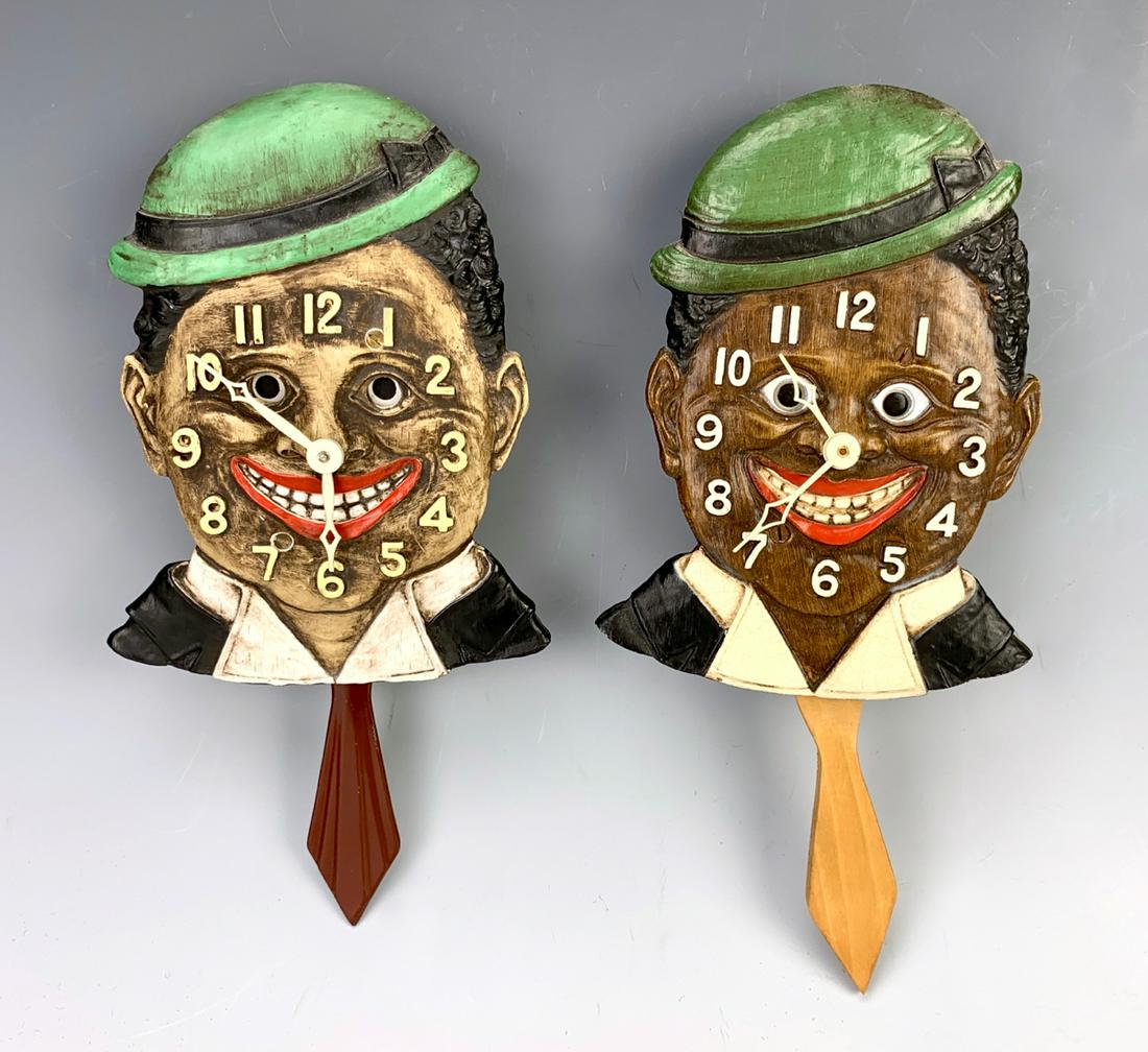 2 Black Americana Lux Animated Clocks: Having a black man wall clock made by Lux Clock Co., eyes move back and forth while running, one key, very good condition, one has replaced neck tie, running at time of auction, 8.5" height **Lifetime