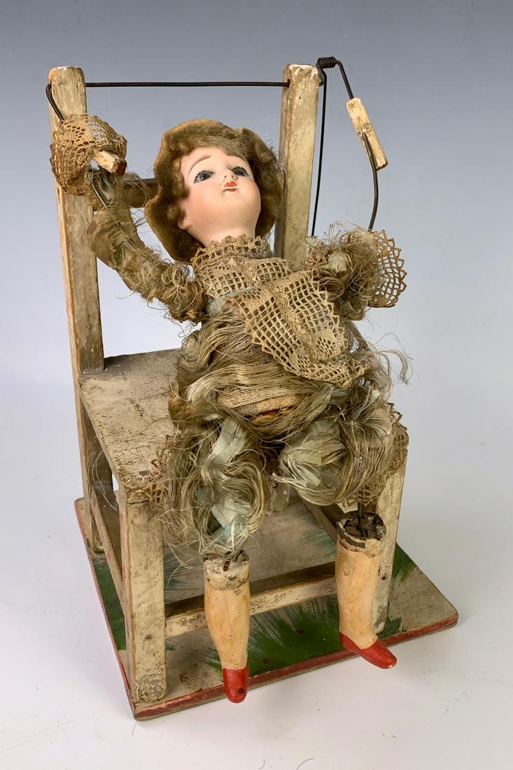 Acrobat Automaton "Flipping Boy" C. 1890: Wonderful antique toy of a boy sitting in wooden chair, when pushed activates boy to flip on chair, German made, unsigned, poured bisque head, open mouth and brown insert eyes, fair to poor condition,