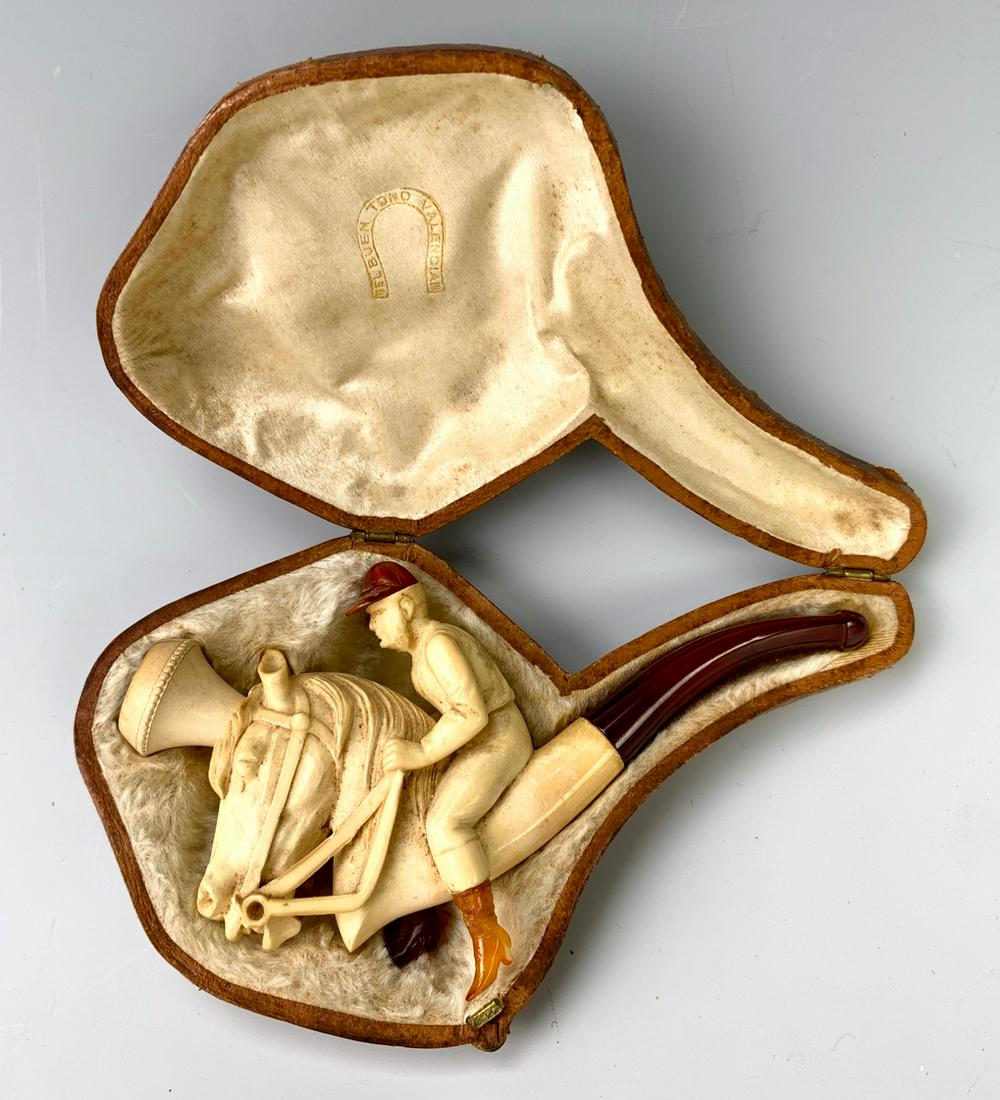 Jockey & Horse Meerschaum Pipe C. 1880: Fabulous unusual meerschaum and amber pipe depicting a jockey on horse with amber hat and boots, meerschaum body with amber stem, comes with original case marked with "Mel Buen Tono Valenoia III", ver
