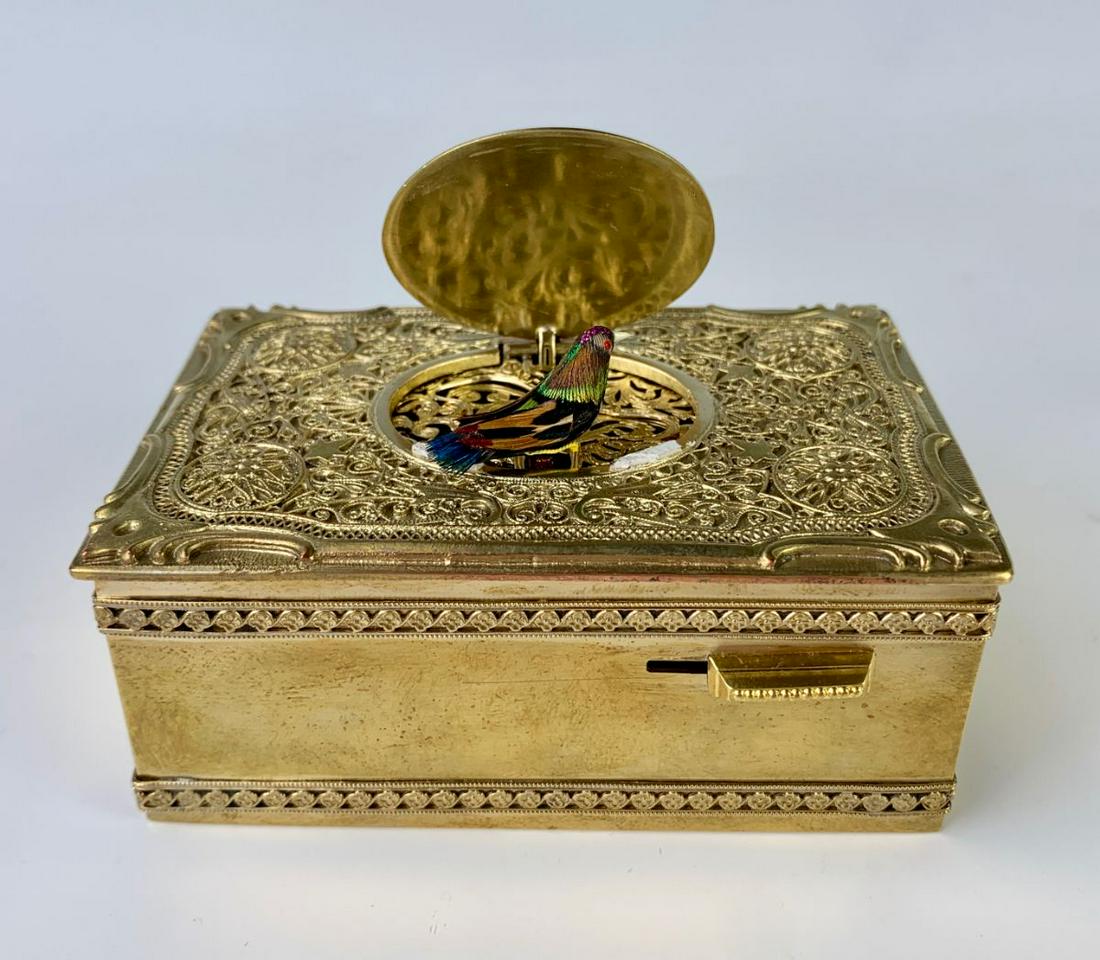 Singing Bird Box with Ornate Gilt Bronze Case: Most likely made by Karl Griesbaum, having a switch on front that activates a singing bird, comes with key, very good condition, 3.75" x 2" x 1.375" Note: Visit our website to see this in action