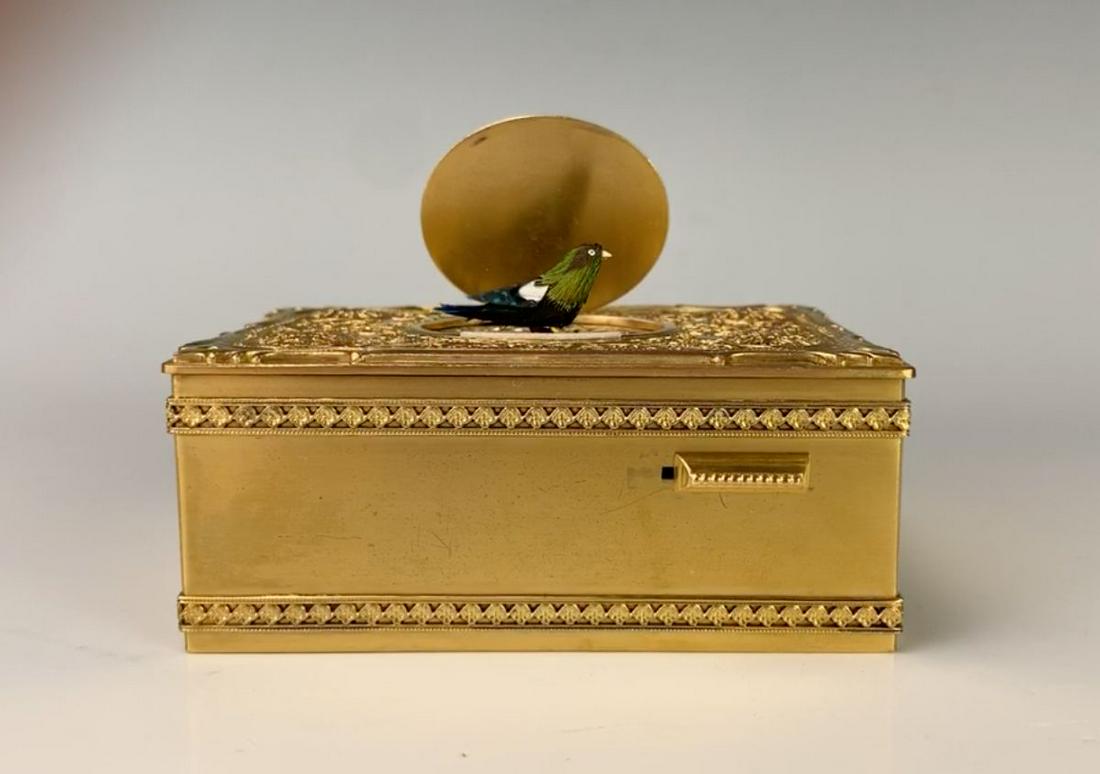 Singing Bird Box with Ornate Gilt Bronze Case: Most likely made by Karl Griesbaum, having a switch on front that activates a singing bird, comes with original display box and key, very good condition, 3.75" x 2" x 1.375" Note: Visit our website to