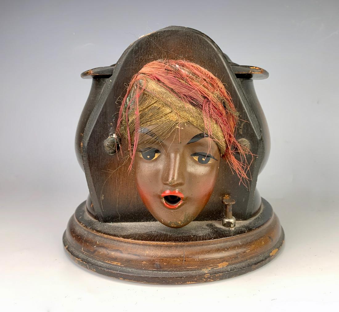 Gypsy Cigarette Dispenser C. 1930's: Humorous cigarette dispenser from the 30's, lift lid to put cigarettes in, push button and cigarette emerges out of gypsy's mouth, good condition, 6.5" height **Lifetime estate collection of Jeannine 