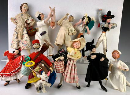 Group of 10 Attributed Klumpe Caricature Dolls: Made in Spain, having a matador, lady with dog, doctor delivering a baby, nurse with syringe, bellhop, flower vendor, boy with cape, orange vendor, dentist and castanet dancer, very good condition,