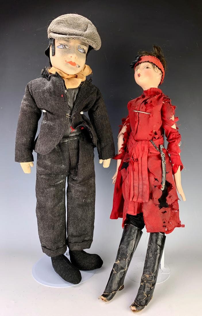 Pair Humorous Boudoir Smoking Dolls: Circa 1930's, having a sexy gal with red dress and tall black boots with composition head, having a sword at her waist, the man wearing a striped suit, grey hat, Lenci style head, both with cigarettes