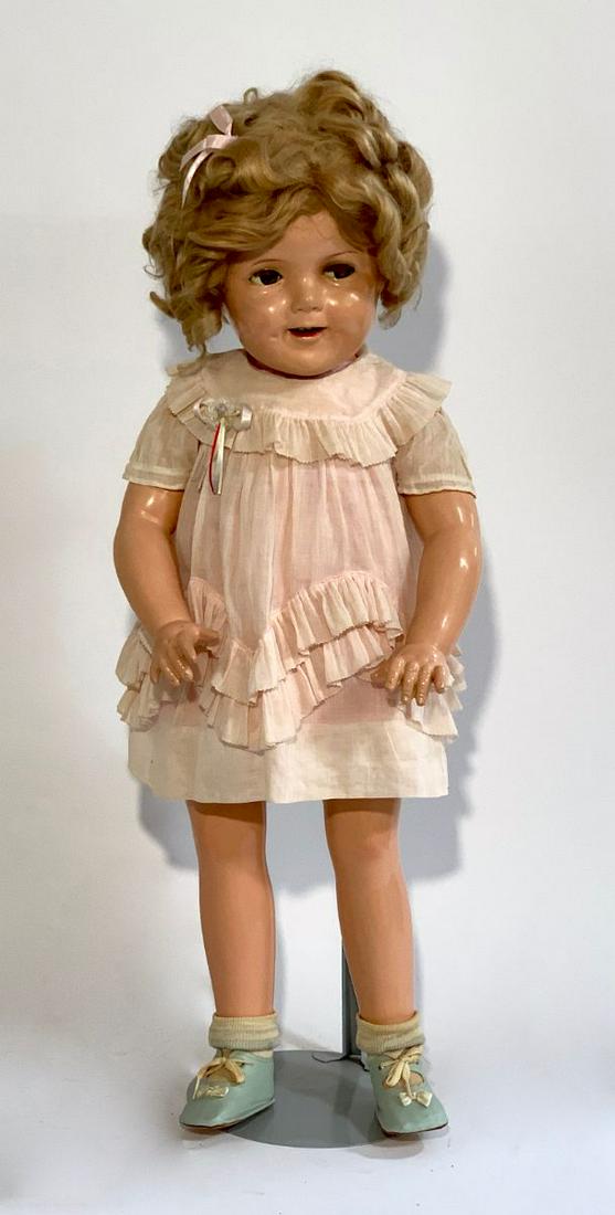 27" American All Composition Shirley Temple Doll: Circa 1935, made by Ideal, flirty sleep eyes, original blond wig, open mouth with teeth, socket head, body jointed at shoulders and hips, possibly repainted (if so, done expertly), head "Shirley Templ