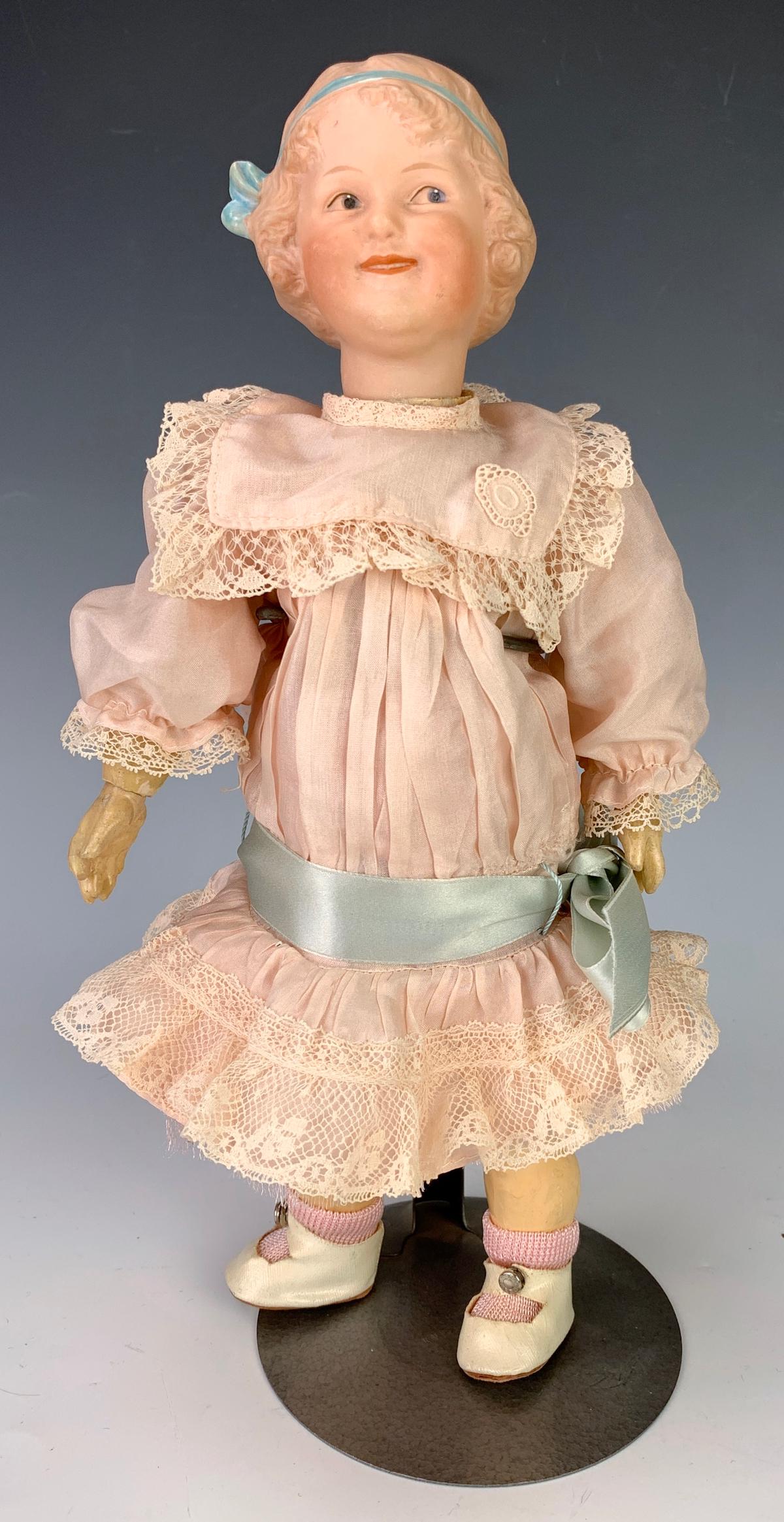 G. Heubach Character Coquette 7763: Bisque head with molded bow, blue intaglio side glancing eyes, German fully jointed composition body, generally excellent condition, 12.5" height *Private collection of a Los Angeles collector.